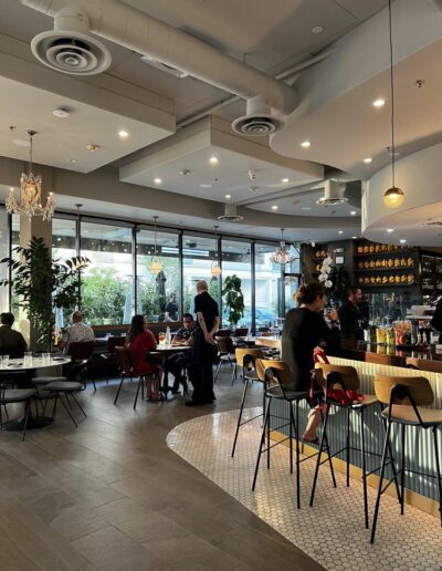 The interior of a restaurant with tables and chairs.