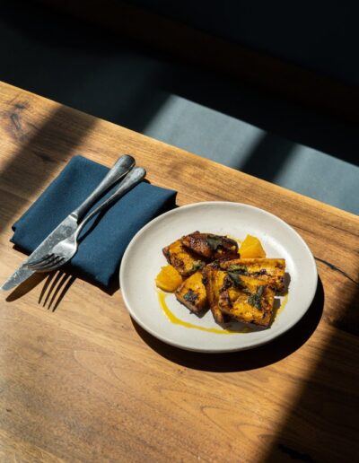 A plate of food on a table with a fork and knife.